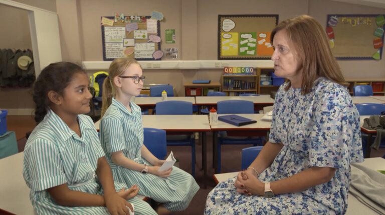 Teacher talking to pupils for World Teachers' Day